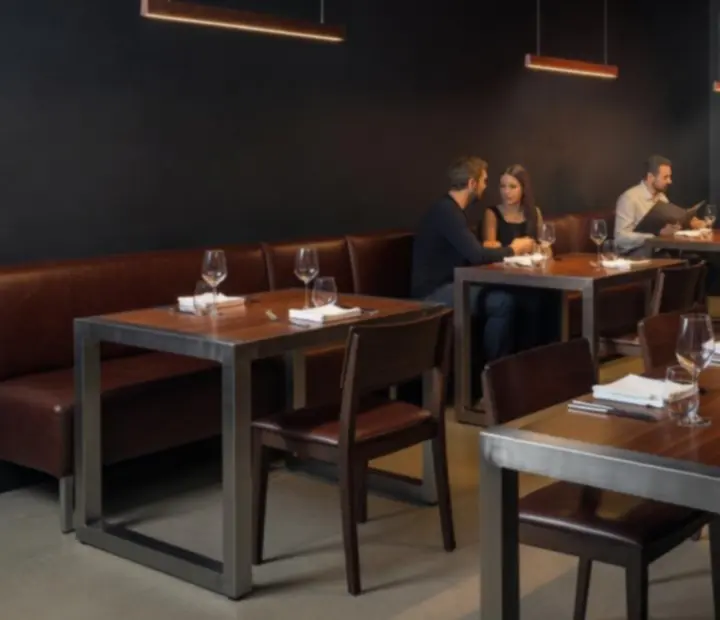 Industrial-luxe dining room with dark charcoal tones and open grill lighting